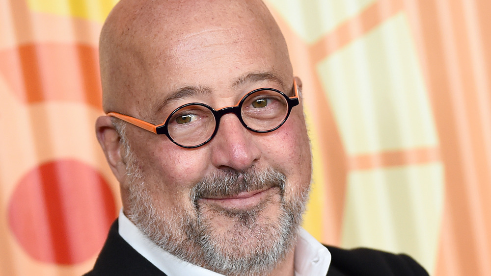 Andrew Zimmern slightly smiling