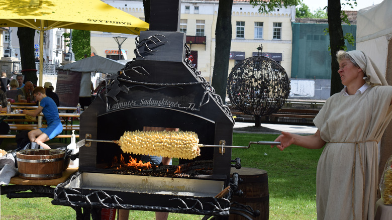 Woman making Lithuanian wedding cake on spit