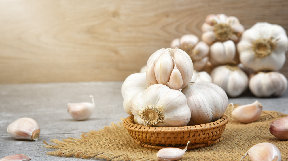 Heads and cloves of garlic on table