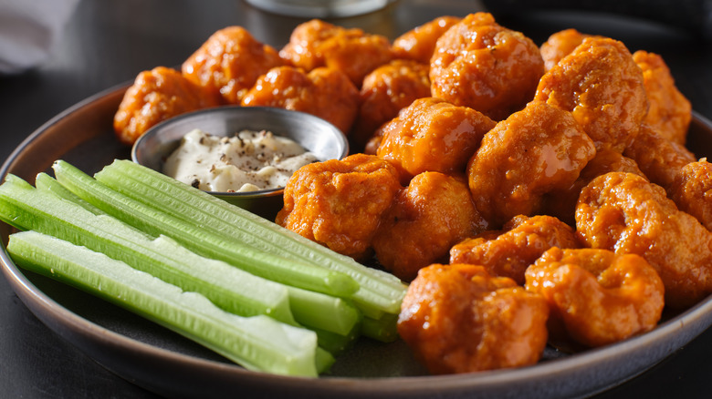 Buffalo wings on plate with celery and dip