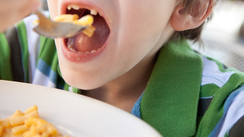 Kid eating mac and cheese