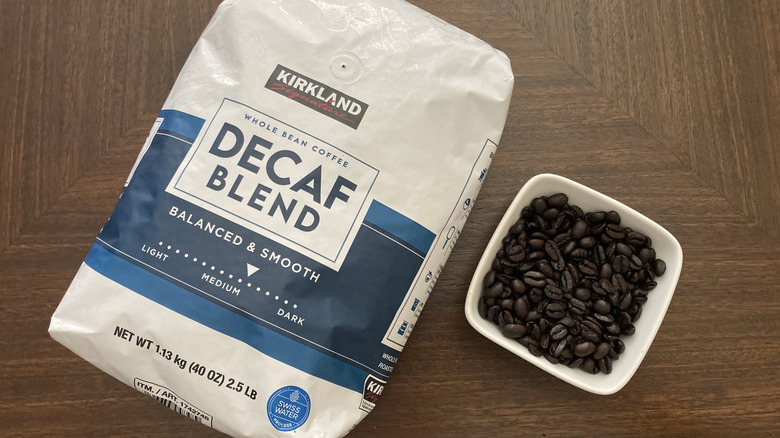 Kirkland Signature decaf blend coffee bag and bowl with coffee beans