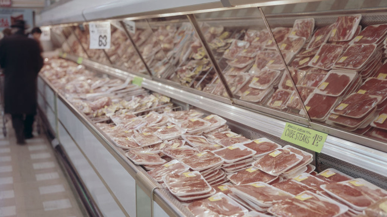 Packaged steaks in the meat department of a circa-1960s supermarket