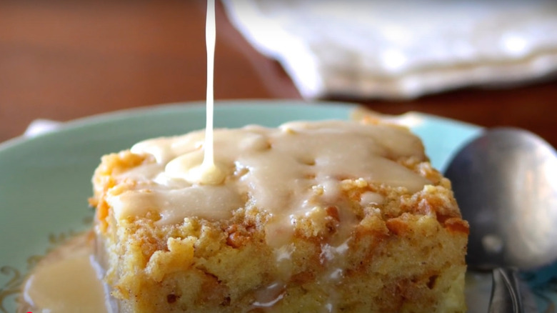 Bread pudding with whiskey cream sauce poured on top, cooked by Cowboy Kent Rollins