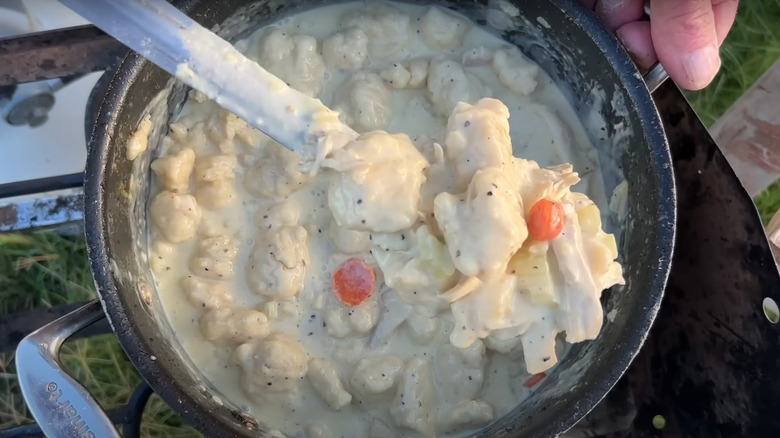 Southern style chicken and dumplings in a pot by Cowboy Kent Rollins
