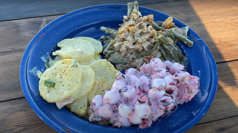 Green bean casserole by Cowboy Kent Rollins in a blue plate on a wooden table