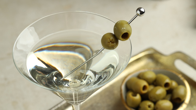 martini with olives on silver pick