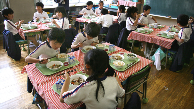 Japanese students eating lunch in classroom