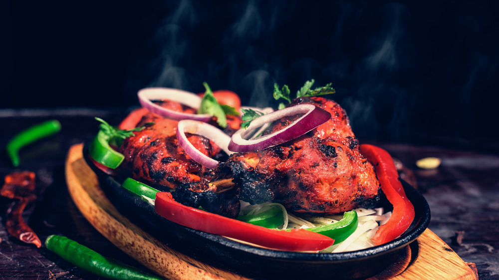 Tandoori chicken on a wooden platter