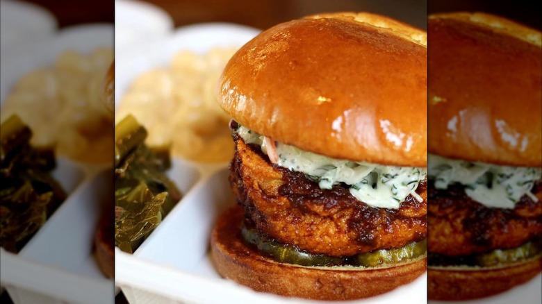 A fried chicken sandwich with pickles and creamy slaw served in a takeout tray