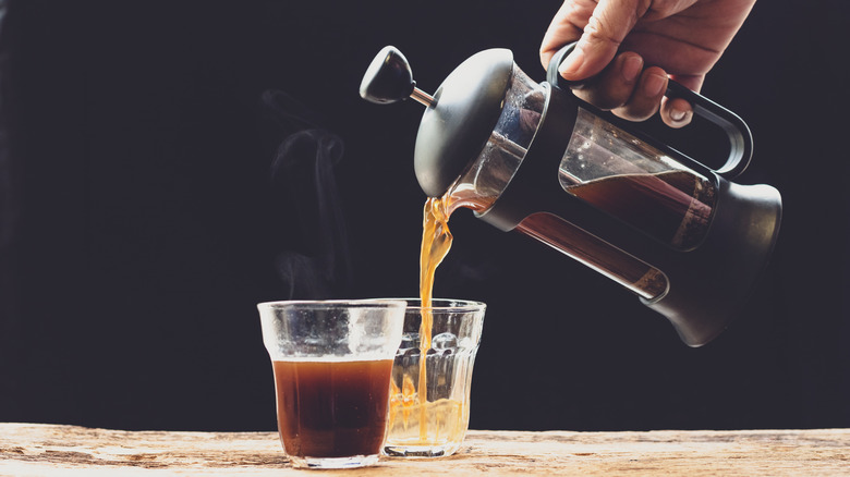 French press pouring coffee into cup