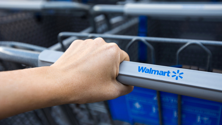 Person grabbing Walmart cart