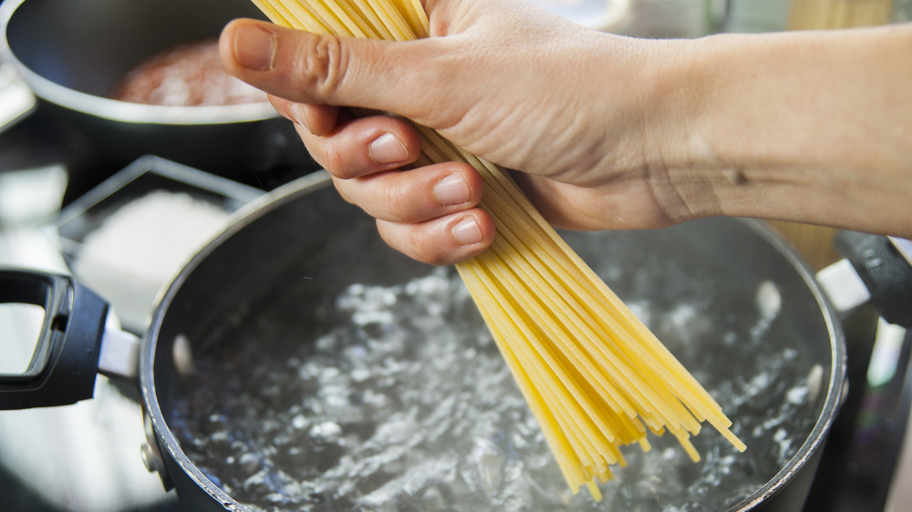Hand dropping pasta 