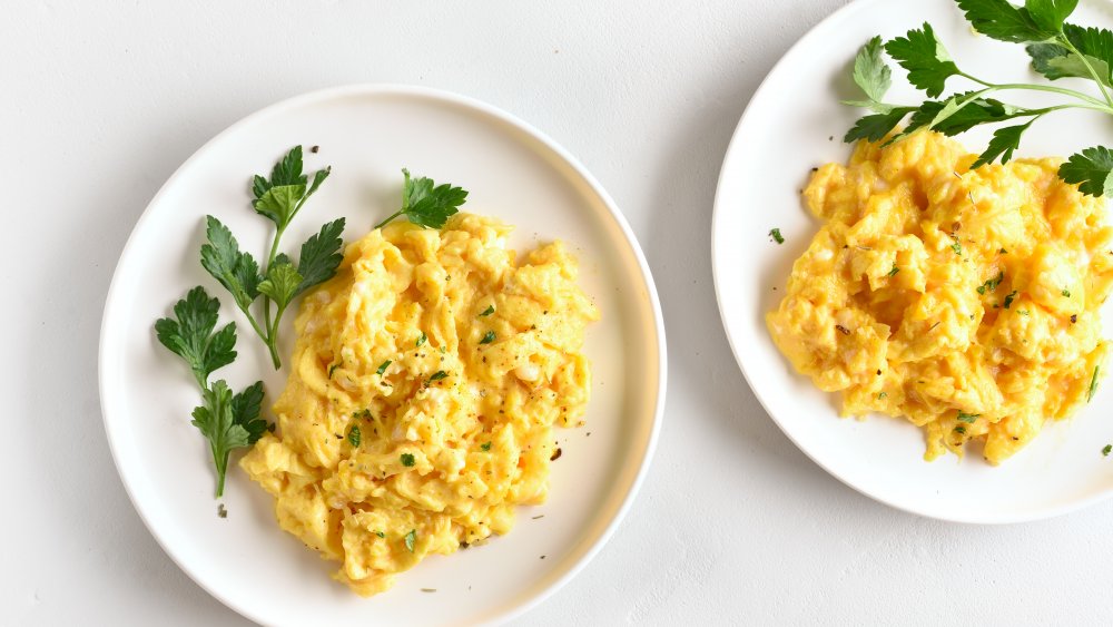 Scrambled eggs on white plates