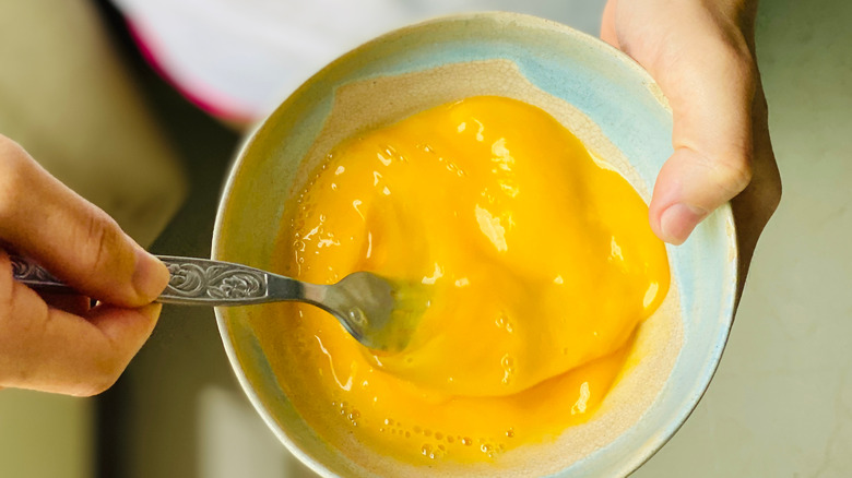 scrambling eggs in a bowl