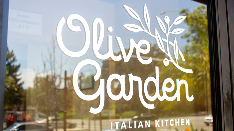 Olive Garden decal on a window of a restaurant