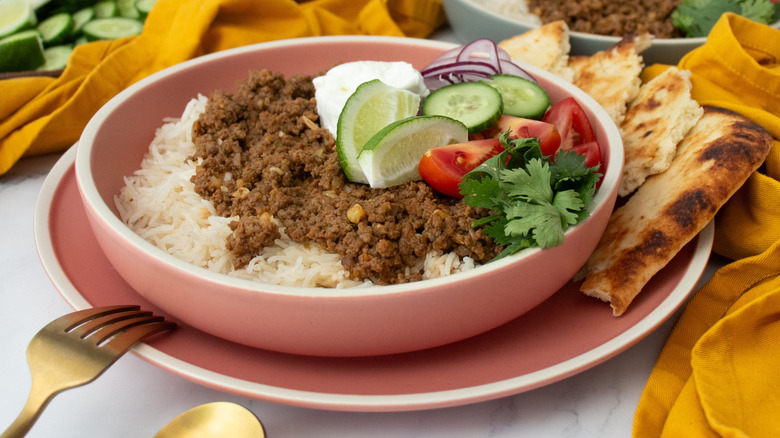 Ground beef keema rice bowl with various fresh toppings