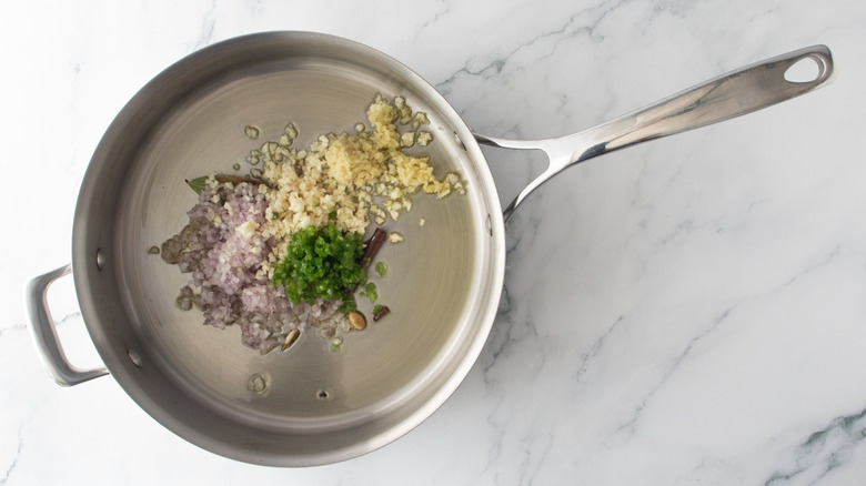 Minced aromatics and oil in pan