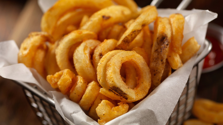 Curly fries in fryer basket