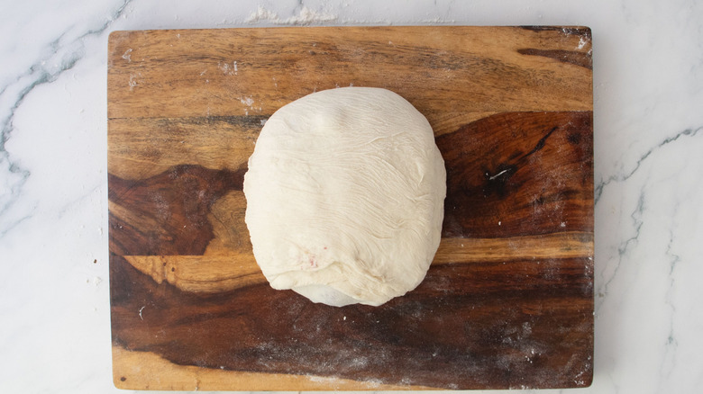 Dough ball on wooden board
