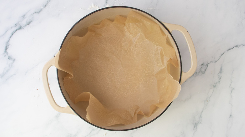 Dutch oven fitted with sheet of parchment paper