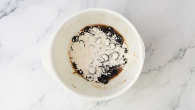 Blueberry mixture with flour on top in bowl