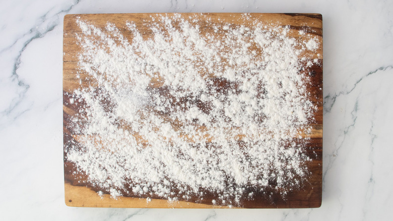 Wooden board sprinkled with flour