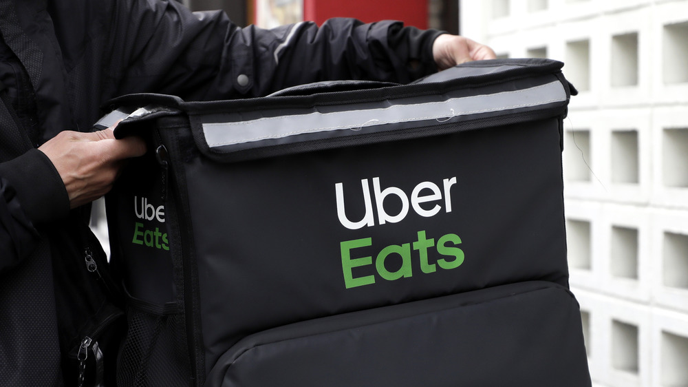 Man carrying Uber Eats bag 