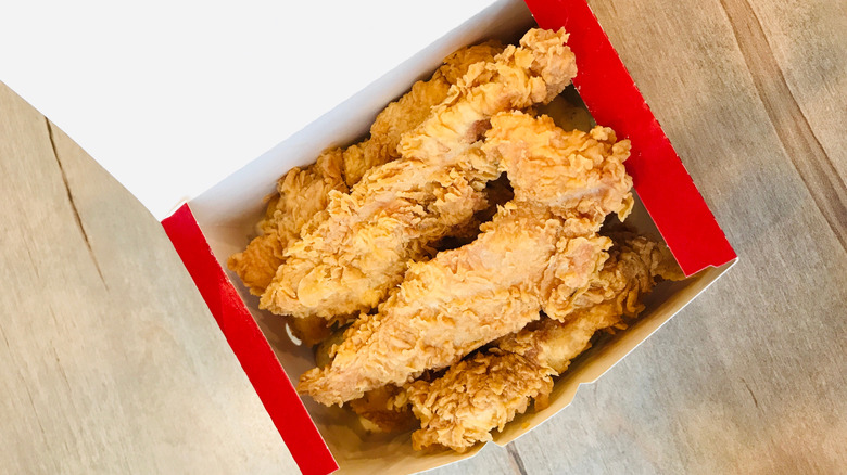 KFC fried chicken tenders in a red box viewed from above