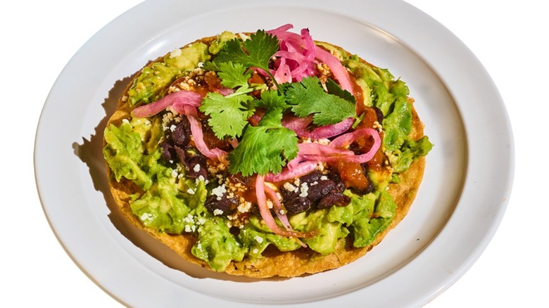 A tostada with guacamole at Tacombi