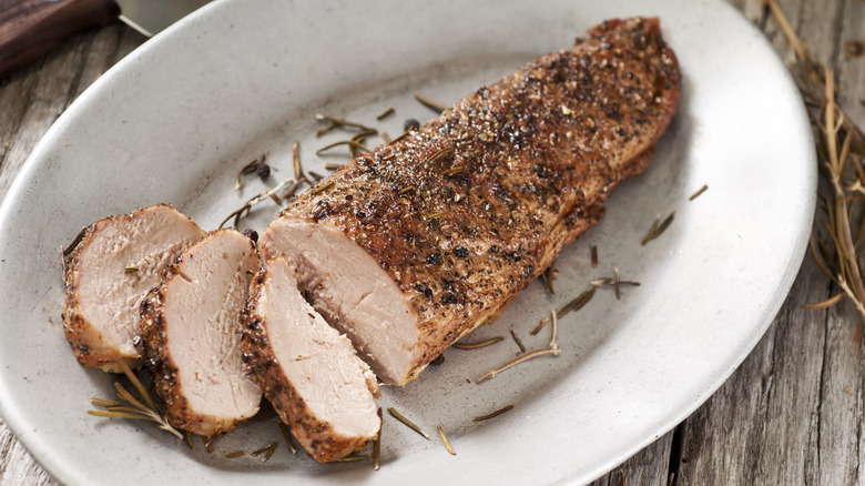 Cooked pork tenderloin on platter