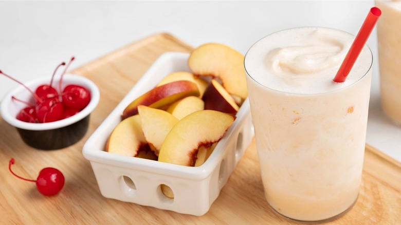 Chick-fil-A peach milkshake with sliced peaches