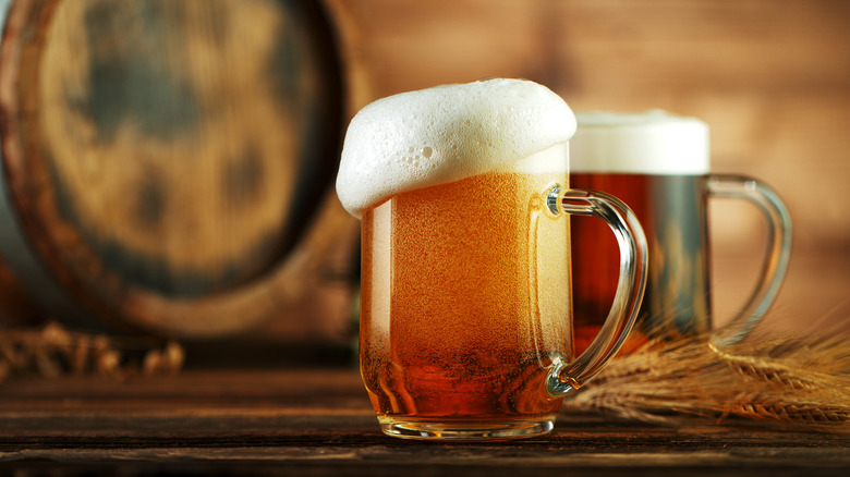 Two beer mugs on a wooden table