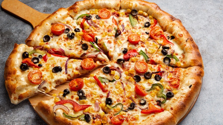 pizza with olives, tomatoes, peppers, and onions