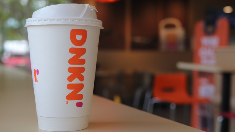 dunkin hot coffee cup on a table