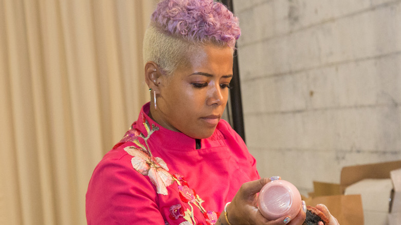Kelis wearing a chef's coat