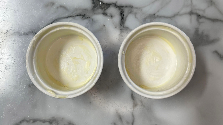 Buttered ramekins on countertop