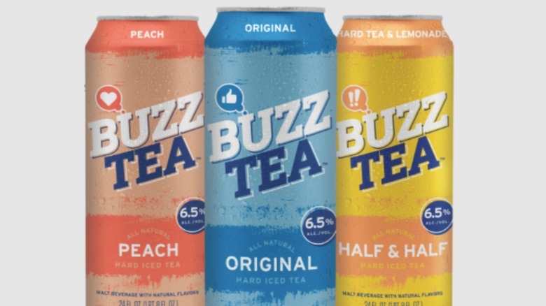 three cans of buzz tea on white background