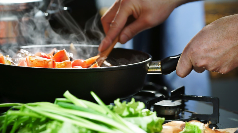 Stirring vegetables in a pan
