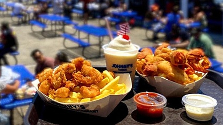 Tray of fried seafood in front of outdoor seaside cafeteria