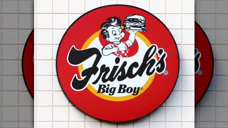 Frisch's Big Boy sign against white tile background.