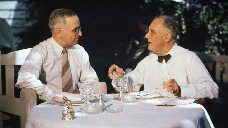 Truman and FDR talking at table