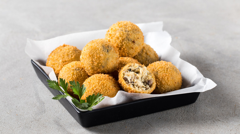 Croquettes in clack tray with parsley