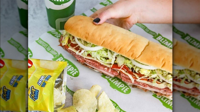 Blimpie Best sandwich with a drink and potato chips