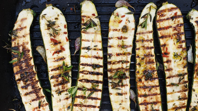 Halved and grilled zucchini with fresh herbs