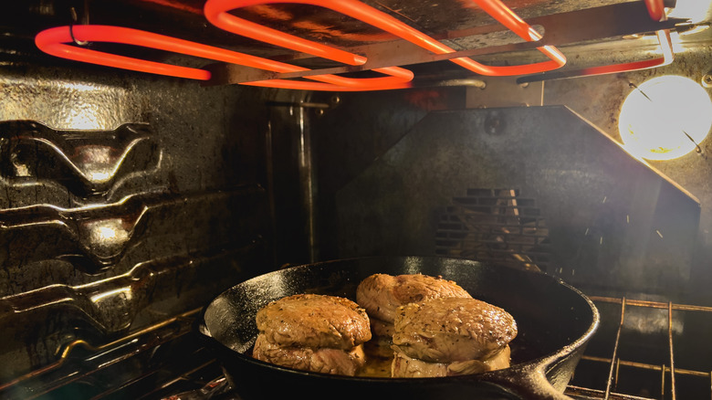 Beef in cast iron pan under broiler.