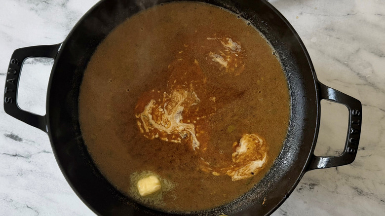 Pan sauce with melting butter and swirls of cream