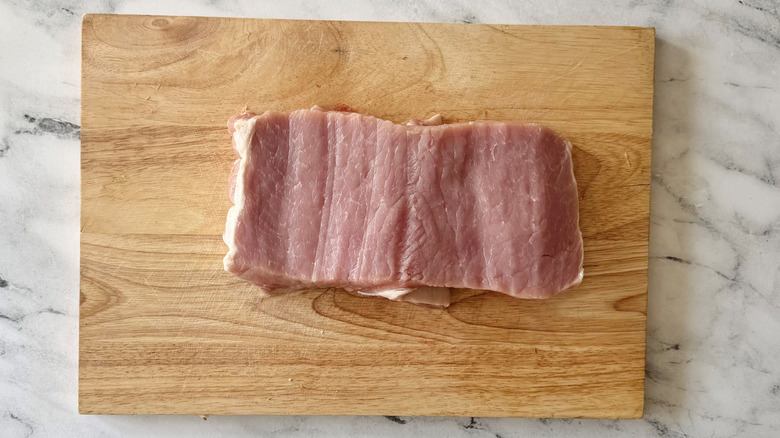 Butterflied pork loin on wooden board