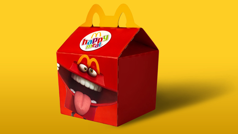 Happy Meal box against yellow backdrop