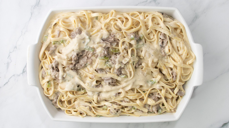 cheesy pasta and steak mixture in baking dish